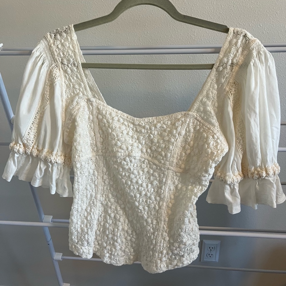 Free People creamy romantic blouse includes puff sleeves and tons of personality